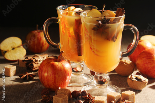 Two cups with hot cider in cold season with cinnamon and anise