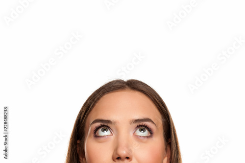 half portrait of a young girl looking up on white background