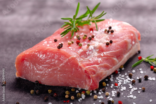 Raw portion of pork chop on a stone background