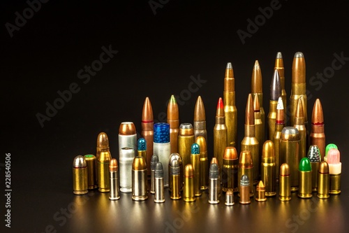 Different types of ammunition on a black background. Sale of weapons and ammunition. The right to hold a gun.