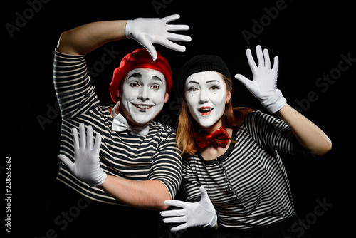 Smiling mimes in striped shirts