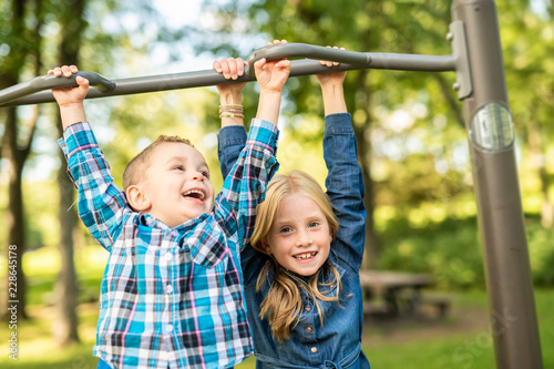 The Two young children having fun on the playground