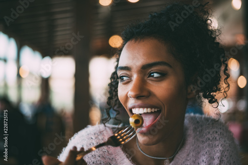 Black woman eating olives