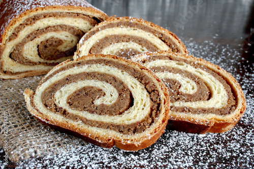 Walnut Bread Roll on wooden background.Croatian orehnjaca 