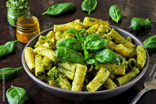 Appetizing pasta with pesto in a bowl on a stylish dark surface