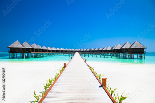 Beautiful tropical resort with wihte beach and turquoise water for relax on Olhuveli island, Maldives.
