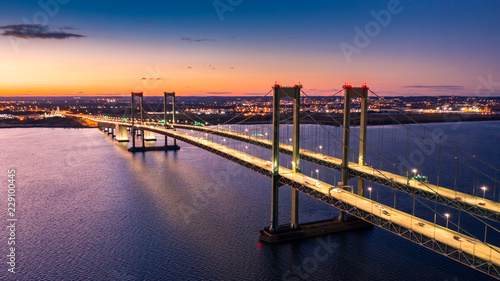 Aerial view of Delaware Memorial Bridge at dusk. The Delaware Memorial Bridge is a set of twin suspension bridges crossing the Delaware River between the states of Delaware and New Jersey