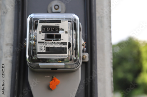 Closeup of outdoor electricity watt meter at the pole.