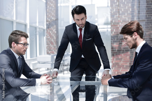 annoyed businessman talking to employees