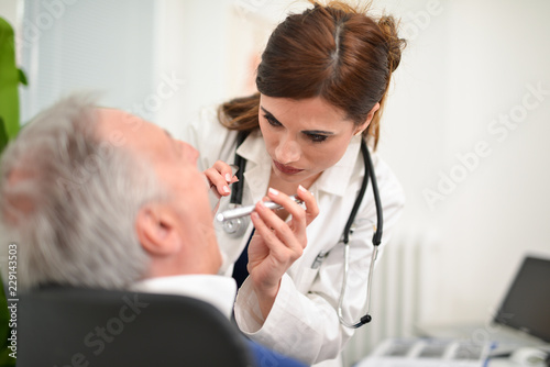 Doctor checking a patient&#39;s throat