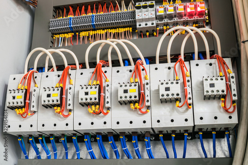 A modern open fuse box contains a lot of automata, connectors, relays, and magnet starters. Distributive electrical box.