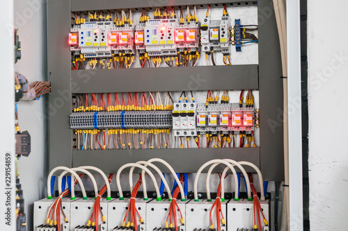 Open control panel for the power supply of the building. A modern electric box contains many wires and devices