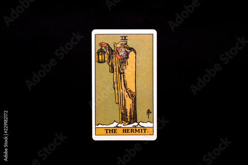 An individual major arcana tarot card isolated on black background. The Hermit.