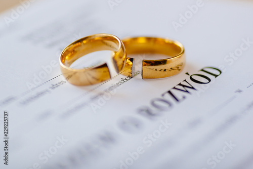 Divorce decree in Polish language and two broken wedding rings