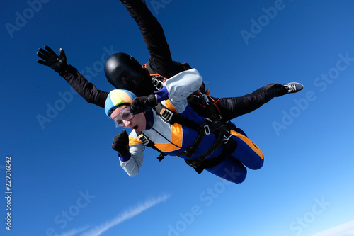 Skydiving. Tandem jump for emotional pretty girl.