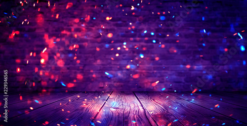 Dark basement room, empty old brick wall, sparks of fire and light on the walls and wooden floor. Dark background with smoke and bright highlights. neon lamps on the wall, night view.