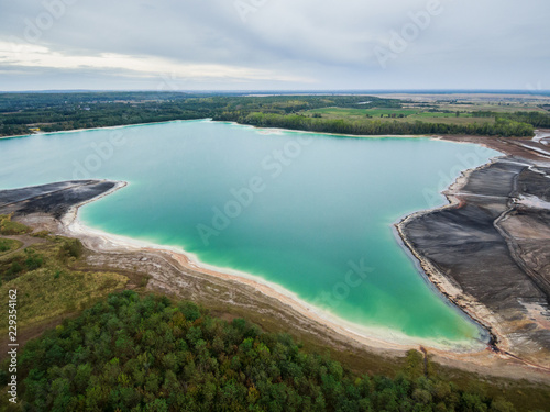 Azure lake "Osadnik Gajowka" top view, abstract fantasy green and brown pattern background