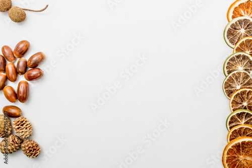 autumn composition with pine cones, slices of dried oranges and acorns, autumn concept, flat lay, top view