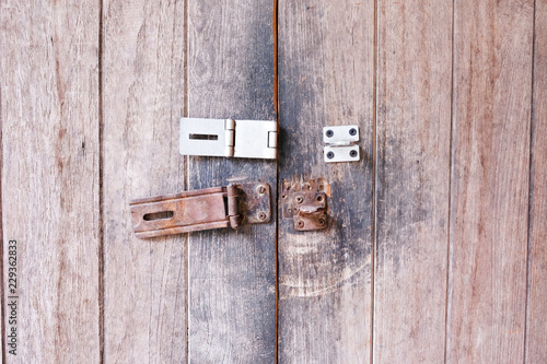 Close up of old hasp lock on the wooden door.