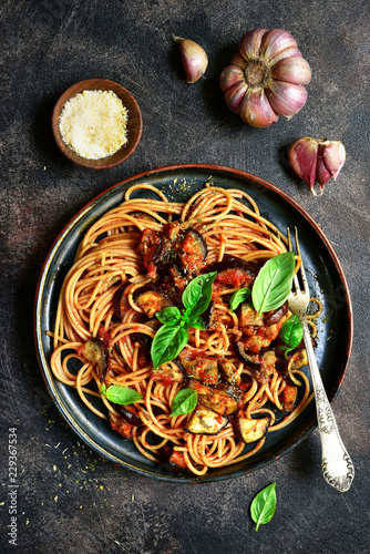 Spaghetti alla norma - traditional italian pasta with eggplants and tomato. Top view.