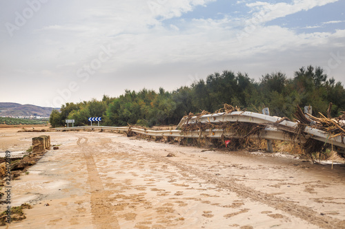 Closed road by muddy flood and river overflow, after historic storm that hit the south of Seville and north of Malaga province, in Spain.