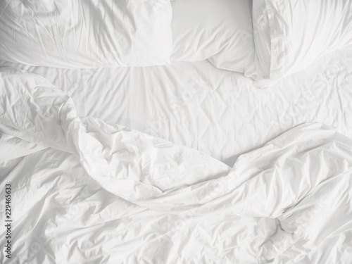 Top view of unmade bedding sheets and pillow ,Unmade messy bed after comfortable sleep concept