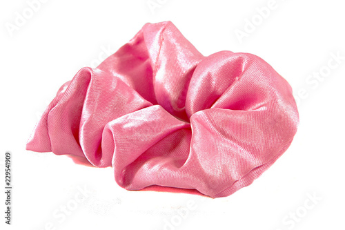 Pink shiny fabric scrunchie for tying hair up, isolated on white