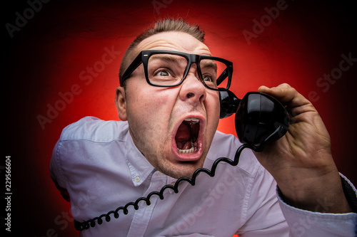 Hysterical and crazy boss screaming on the phone. Bad boss concept. Harassing phone calls.