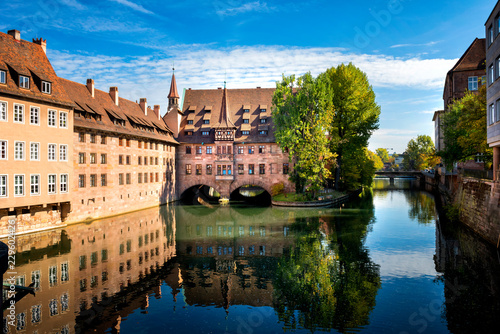 Nuremberg, Heilig-Geist-Spital which is reflected in the waters of the Pegnitz river. Franconia, Germany