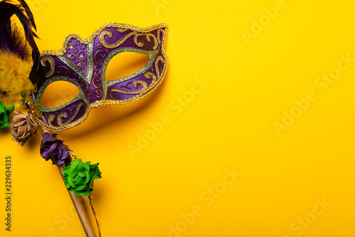 Colorful Mardi Gras mas on a yellow background