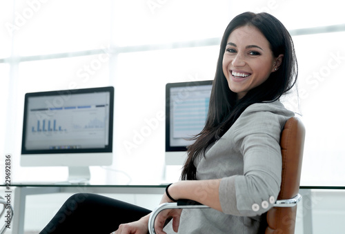 young employee of the company works with computer data.