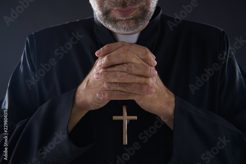 Praying hands priest portrait of male pastor