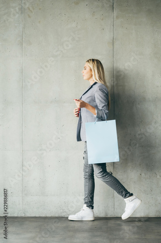 shopping paper bag on woman hand. retail and goods buying concept.