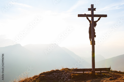 Wooden crucifix with Jesus on a mountain hill