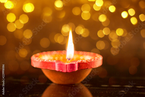 Happy Diwali Clay Diya lamps lit during Dipavali Hindu festival of lights celebration