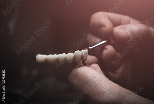 A dental technician makes a prosthetic teeth. laboratory. close-up.