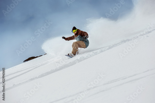 Snowboarder offpiste slope downhill fast