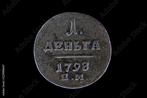 old Russian coin 1 Denga 1798 on black isolated background