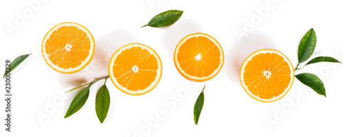  Half cut oranges and green leaves.