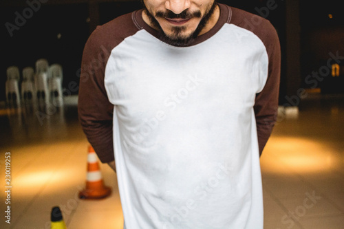 man wearing a white and brown raglan shirt