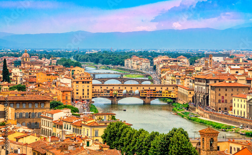 Panoramic view of medieval stone bridge Ponte Vecchio over Arno river in Florence (Firenze), Tuscany, Italy, Europe. Florence cityscape. Architecture and landmark of Florence and Italy