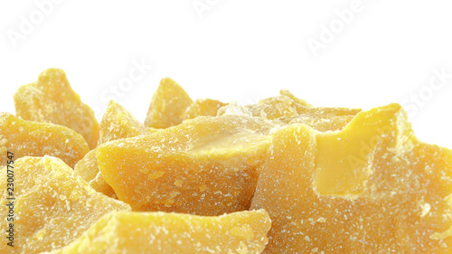 Pieces of natural beeswax are isolated on a white background