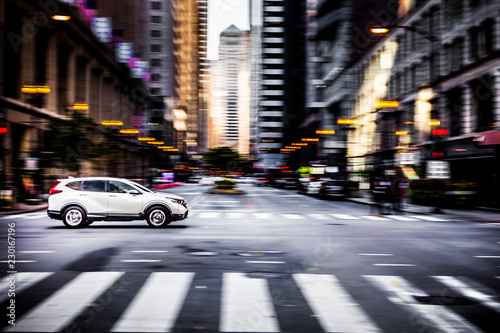 Car speeding down a road in downtown Chicago