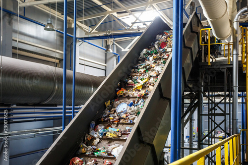 moving conveyor transporter on Modern waste recycling processing plant. Separate and sorting garbage collection. Recycling and storage of waste for further disposal.