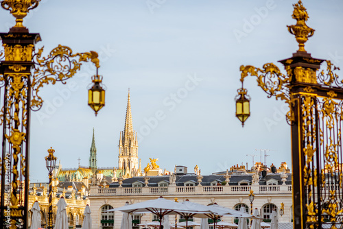 Cityscape view on the central square with beautiful Golden gates and cathedral tower in Nancy, France
