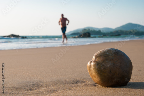 Сoconut on the beach and the running man