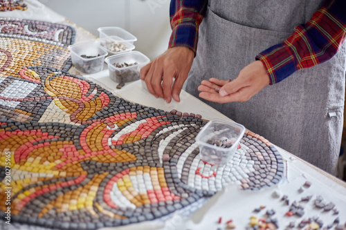 Crop artist composing mosaic
