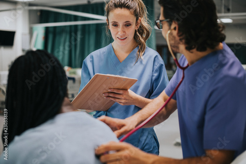 Young male physician examining a patient