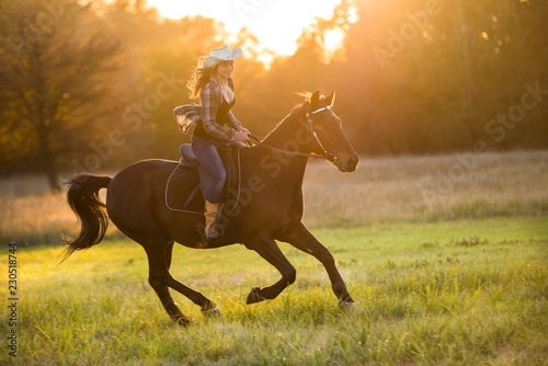 Girl equestrian rider riding a beautiful horse