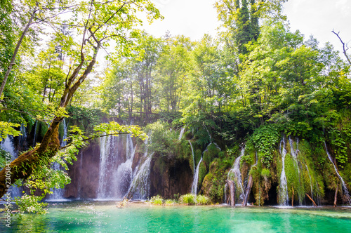 Mountains lake with waterfall surrounded by forest in Plitvice Lakes National Park, Croatia